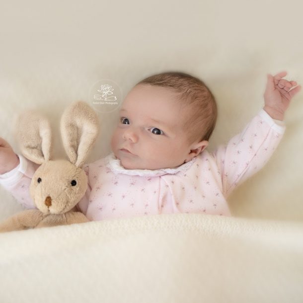 Newborn photography lifestyle pose baby with teddy