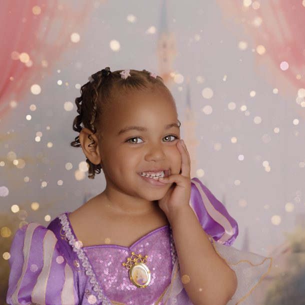 little girl dressed as princess smiling