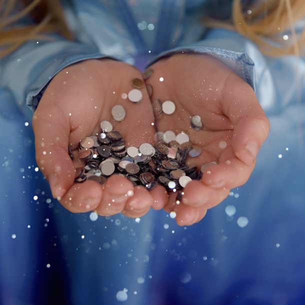 little girl holding glitter